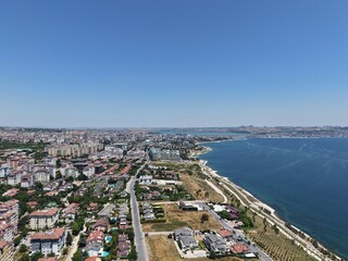 Fototapeta premium Aerial Panoramic View of Coastal Residential Neighborhood and Blue Sea Horizon