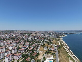 Fototapeta premium Aerial Panoramic View of Coastal Residential Neighborhood and Blue Sea Horizon