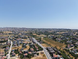Fototapeta premium Aerial Panoramic View of Coastal Residential Neighborhood and Blue Sea Horizon