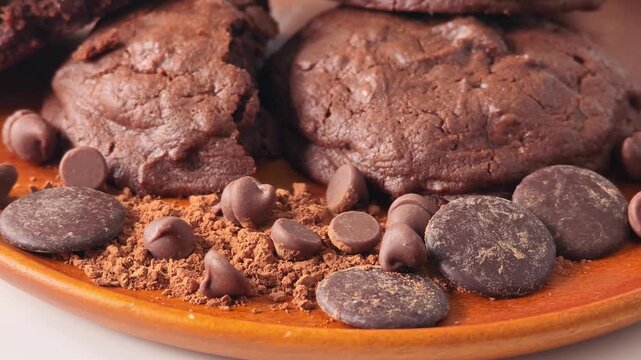 Brownies and chocolates on a wooden plate.