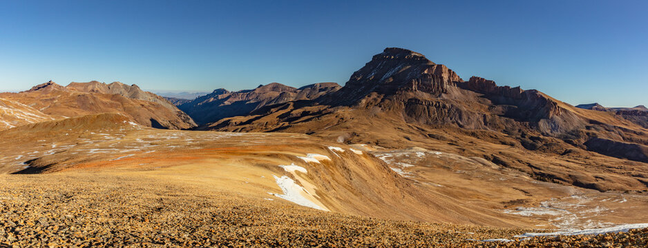 This scenic autumn San Juan Mountain panorama features Colorado 14er Uncompahgre Peak rising above the colorful Iron Beds.
