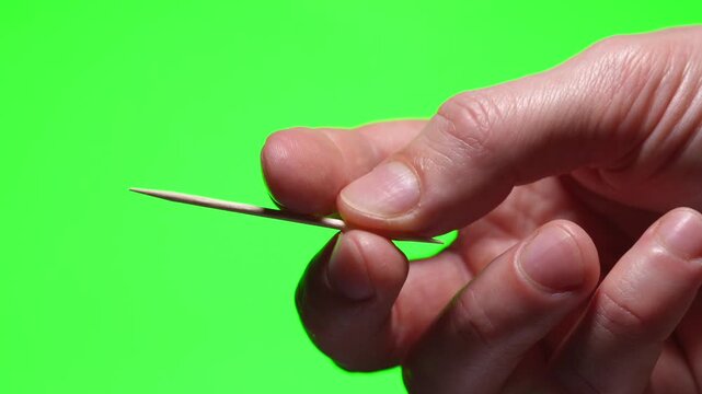 toothpick close-up on a green isolated background