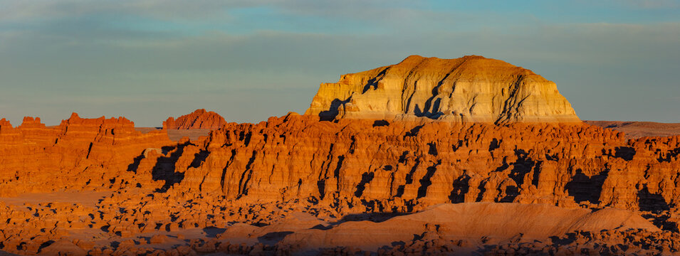 This panorama features  the eroded hoodoo formations of Goblin Valley State Park, Utah, in soft light at sunset.
