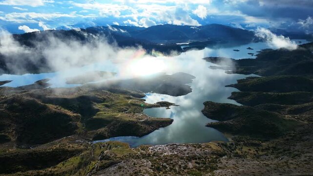 Aerial drone cinematic video of amazing artificial lake Aoou with beautiful nature and reflecting clouds near picturesque village of Metsovo surrounded by mountains of Pindus, Epirus, Greece