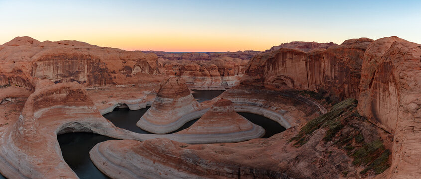 This stunning panorama features a colorful sky at sunrise above Reflection Canyon, Lake Powell.