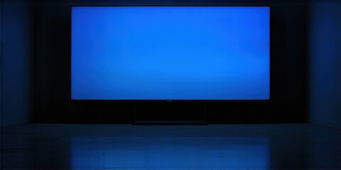 Fototapeta premium Dark room features large blue screen television. Minimalist setup, modern design, sleek presentation. Focus on display technology.