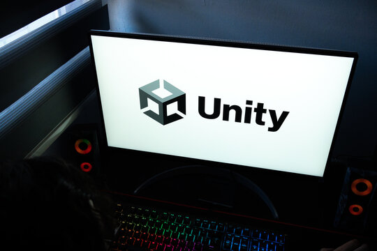 Punta Arenas, Chile &ndash; March 07, 2026: A desktop PC monitor showing the official Unity game engine logo in a dark room with a backlit gaming keyboard