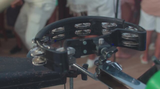 musician playing a crescent-shaped tambourine in concert