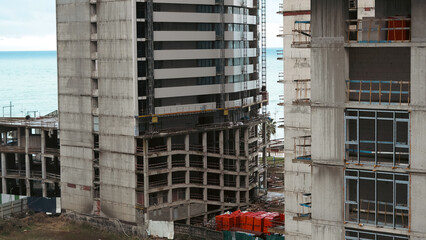 Construction site with two high-rise buildings near the waterfront