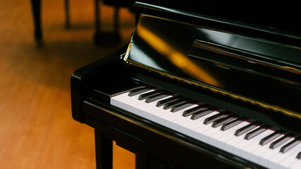 Elegant Black Upright Piano Keys in Soft Ambient Lighting - Close Up View © maha