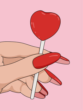 Woman's Hand Closeup Holding Glossy Red Heart Candy Lollipop Isolated on Pink Background. Cute Love Party Valentines Concept
