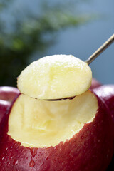Fresh Red Apple Flesh Being Scooped with Spoon - Healthy Fruit Close-up
