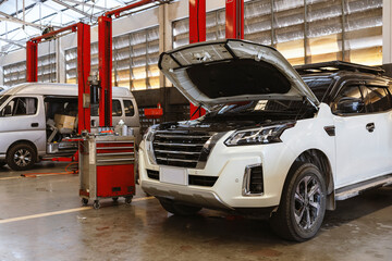 Cars on Hydraulic Lifts Inside Modern Auto Repair Service Garage