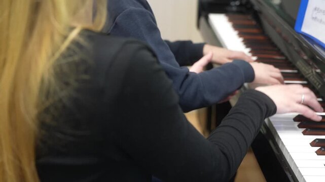 The boy who gives lessons in a piano. Close up. High quality video