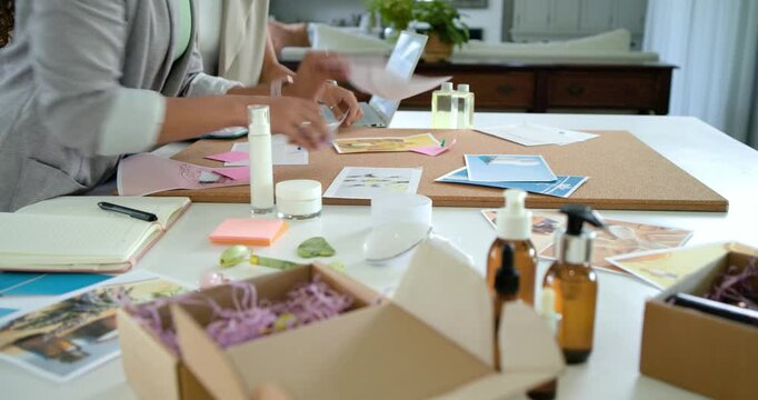 African American women starting by opening shipping box, arranging packaging mockups and jars