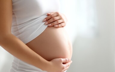 Pregnant Woman Showing Visible Belly with Fetus Beneath White Shirt