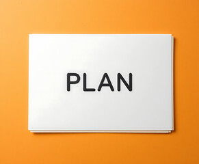 White card with plan text on orange background black letters
