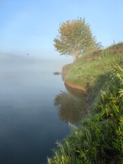Fog at dawn on the river, summer landscape.