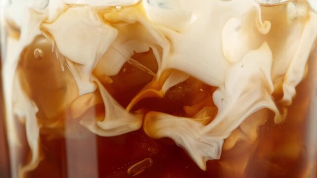Super Slow Motion Shot of Pouring Milk into Ice Coffee , Filmed on High Speed Cinematic Camera