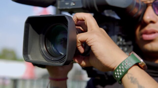 Cameraman filming live event with professional camera