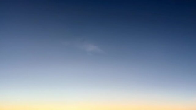 Vast Blue Sky with a Single Wispy Cloud at Sunset.