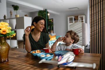 Fototapeta premium Mother and son enjoying family breakfast at home