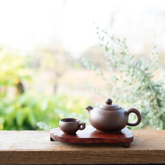 Brown Earthenware tea set on red wooden tray