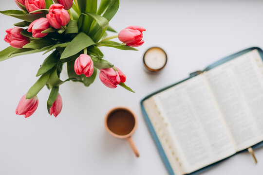 Open Bible coffee candle tulips flat lay Bible study cozy lifestyle.