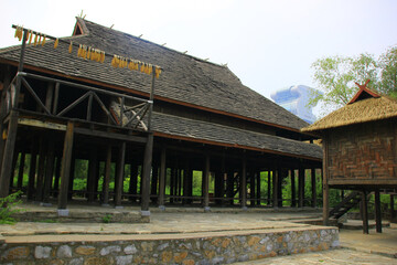Fototapeta premium Traditional Chinese Architecture with Thatched Roof and Wooden Pillars