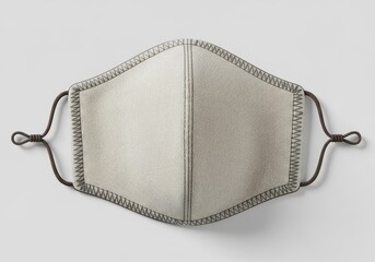 Protective fabric face covering displays detailed stitching and adjustable ear loops against a plain background