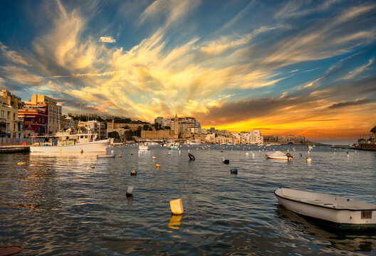Marsaskala, Malta &ndash; harbor with fishing boats and sunset over the coast