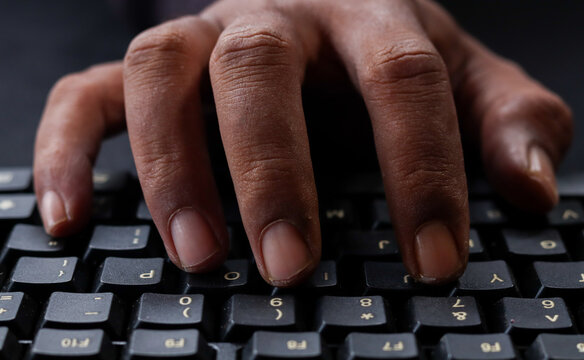 A program code is typing on computer keyboard . Hacker is using computer. Man hands are searching in web or working on pc. Concept of digital cyber security and vpn data protection.