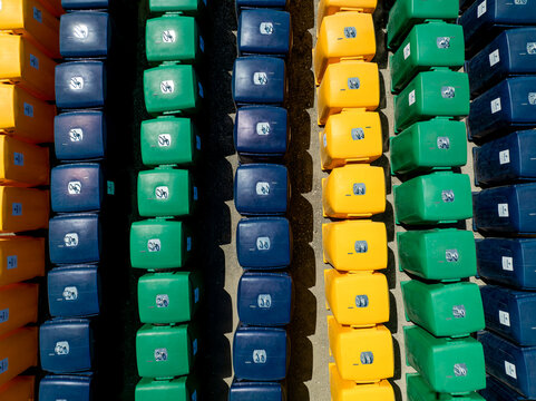 Aerial view of colorful plastic blocks arranged in rows, creating a vibrant mosaic of yellow, green, and blue hues, Lisbon, Lisbon, Portugal.