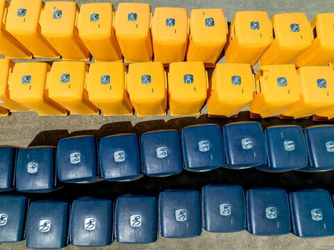 Aerial view of rows of portable toilets in contrasting yellow and blue hues creating a geometric pattern on the ground, Lisbon, Lisbon, Portugal.
