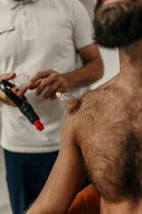 Patient receiving therapeutic cupping on shoulder for discomfort