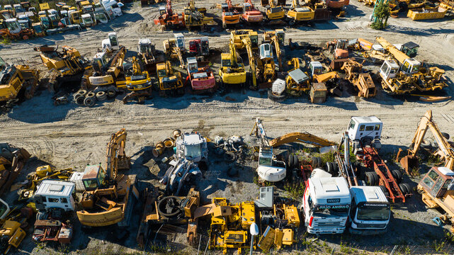 Aerial view of a multitude of heavy machinery, excavators, and trucks lay scattered across a vast yard, Nanclares de la Oca, Basque Country, Spain.
