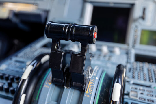 Close-up view of engine throttle levers inside commercial airplane cockpit. Aviation control, flight operation, pilot workspace, technology, and transportation concept.