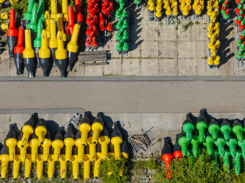 Aerial view of colorful buoys contrasting against the concrete and lush greenery near Aquaduct Veluwemeer, Harderwijk, Gelderland, Netherlands.