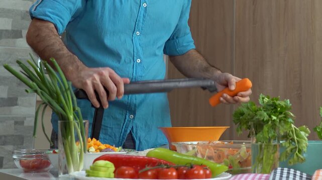 Close Up of Slicing Fresh Carrots with Mandoline on Wooden Board. High-quality vegetarian cooking and healthy lifestyle concept.
Search VITAL-CHEF54 for more from this collection.