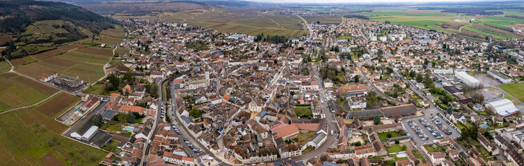 Obraz premium Aerial panoramic view above the old town around the city Nuits-Saint-Georges in France on a sunny autumn day. 