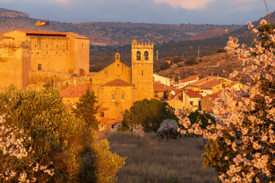 Mora de Rubielos medieval village with a castle during the Spring blossom   Beautiful nature scene with blooming almond tree and the Gudar mountains   in Teruel Aragon Spain