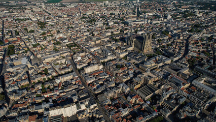 Aerial panoramic view above the old town around the city Reims in France on a sunny summer day.