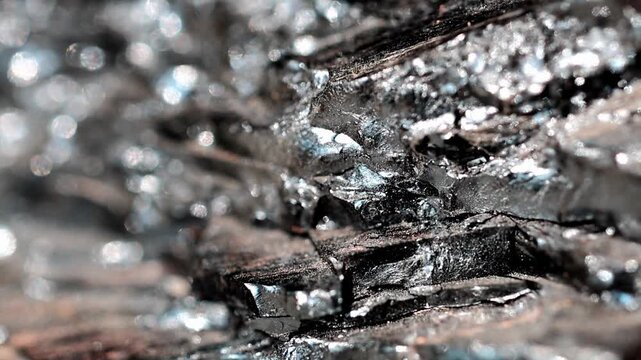 Slow Motion Macro Shot of Chunk of anthracite coal showing its crystalline structure, reflective light on the surface, revealing geological formations at 180 fps High quality footage