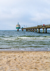 Fototapeta premium Zinnowitz pier on Usedom island at Baltic Sea, Germany. Diving gondola at seaside resort. Travel destination and coastal tourism concept.