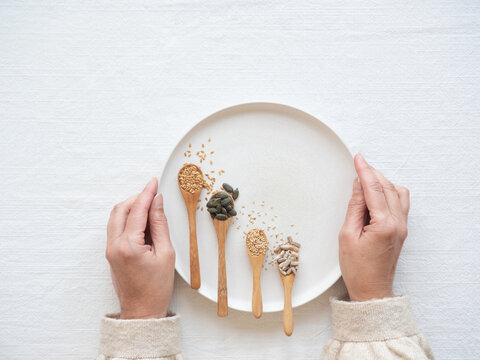 Woman holding plate with seeds for hormone balance