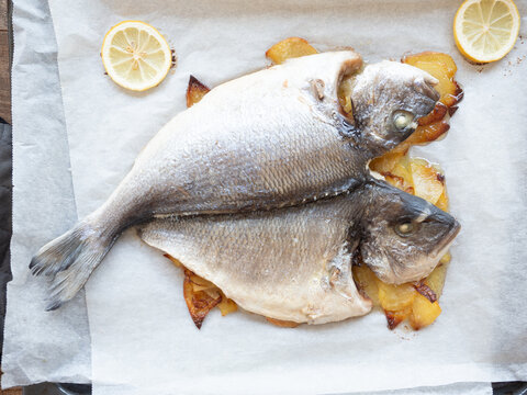 Roasted gilthead sea bream with potatoes and lemon