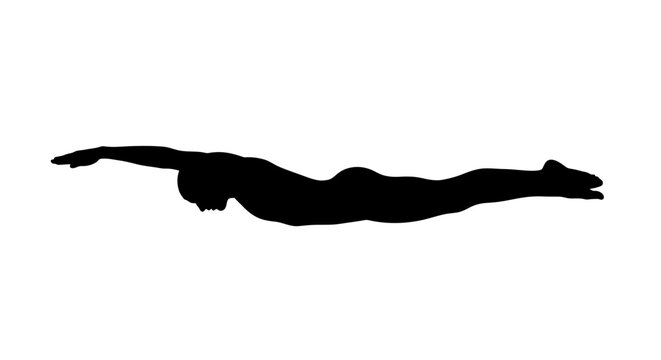 Silhouette of a person swimming freestyle.