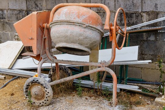 Concrete mixer for mixing construction materials, cement and concrete. Real estate bubble, housing overbuilding.