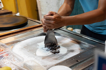 Fototapeta premium Vietnamese Rolled Ice Cream Being Prepared at Hoi An Market