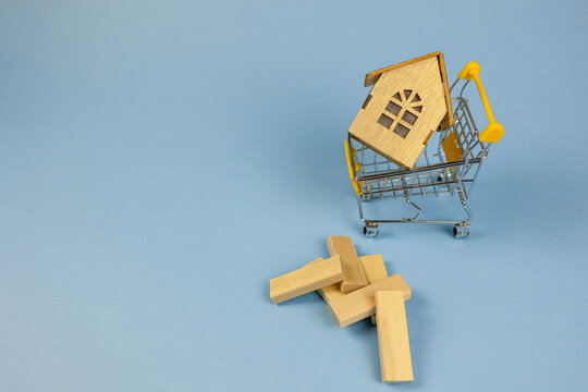 miniature home wobbling, petite residence collapsing with scattered wooden pieces, miniature structure destabilizing among scattered wooden blocks illustrating financial market fluctuations
